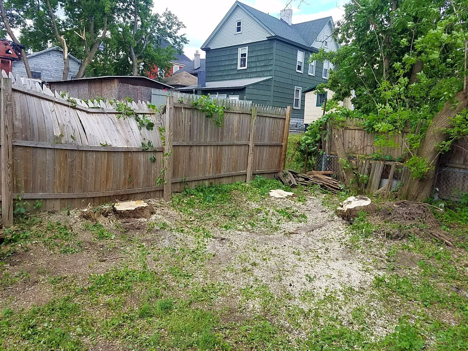 storm damage cleanup around fence